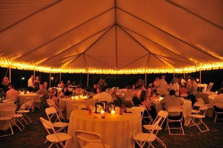 Elegant outdoor event tent with golden string lights