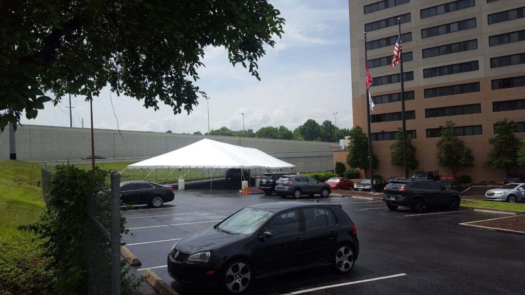White tent in parking lot setting