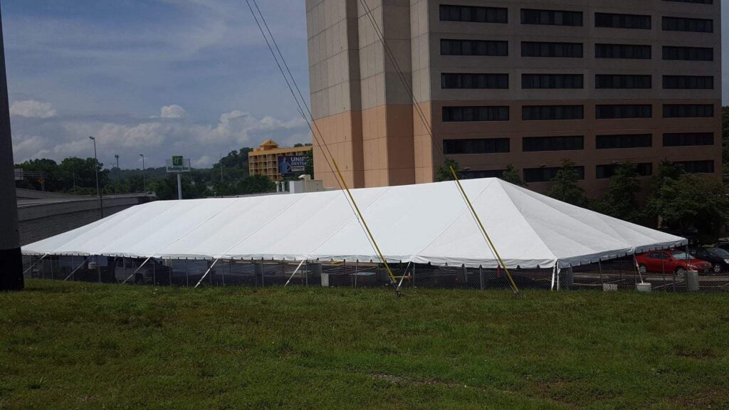White peaked tent in open field