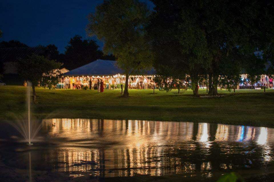 Evening event with illuminated tent and fountain
